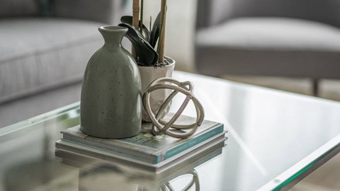 a vase sitting on top of a glass coffee table