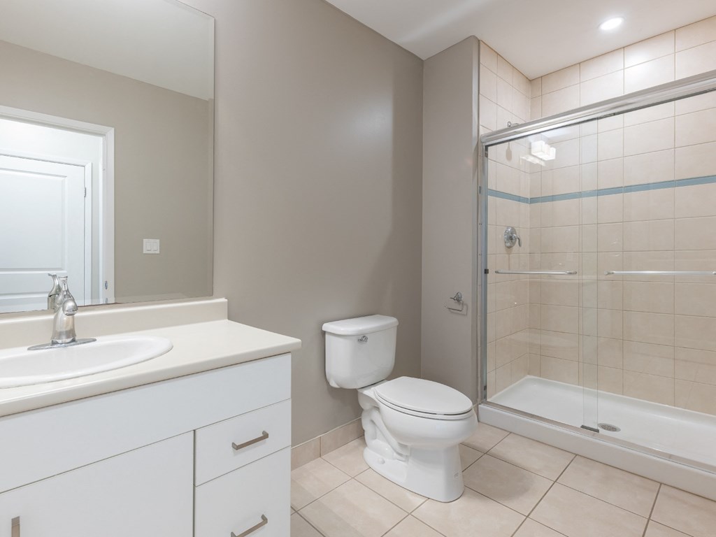 A white toilet sits next to a sink in a bathroom.