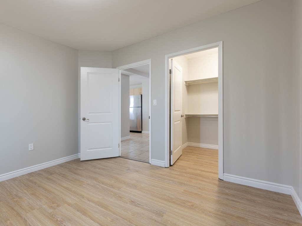 A room with a white door and a white wall.