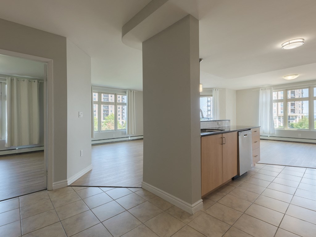 A kitchen with a dishwasher and a refrigerator.