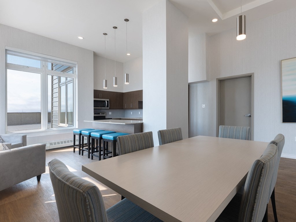 A modern dining room with a large table and chairs.