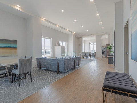 A large, modern room with a long table and chairs.