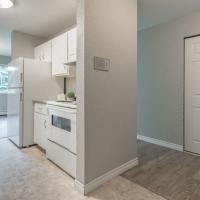 a kitchen with a white stove and a refrigerator