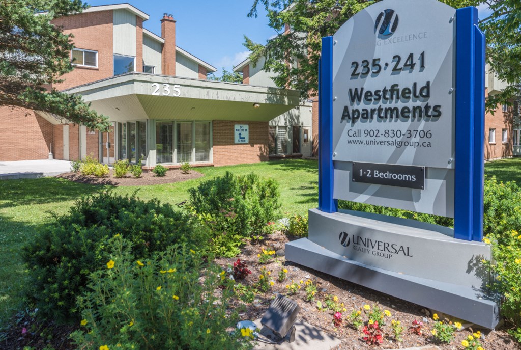 a sign apartments in front of a building