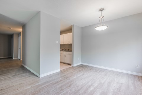 a renovated living room and kitchen in a new home