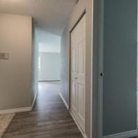 a hallway with a white door and a hall way