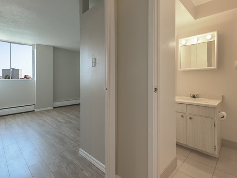 A bathroom with a sink, mirror, and cabinet.