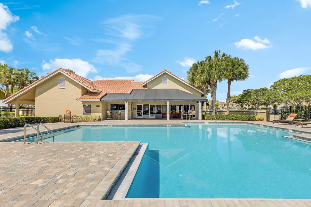 a swimming pool with a house in the background
