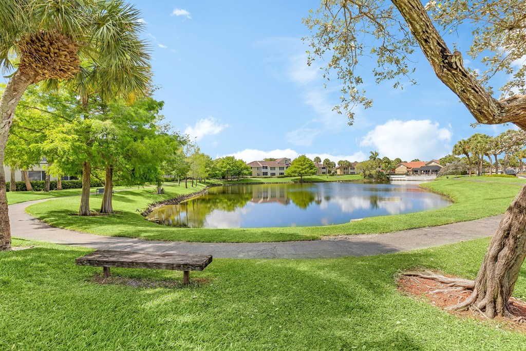 a park with a pond and a picnic table