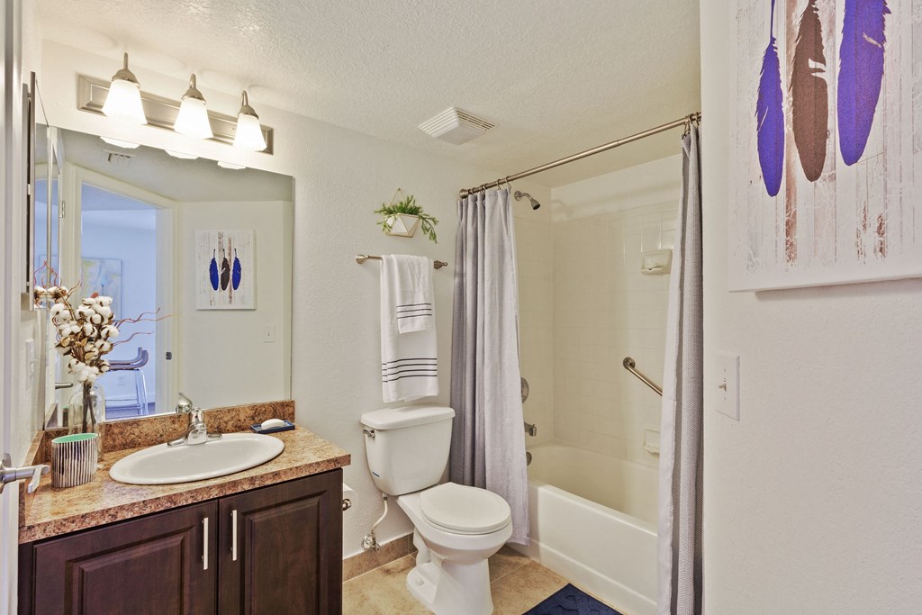 A bathroom with a sink, toilet, and bathtub.