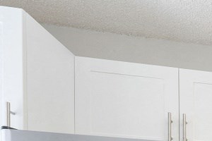Kitchen with cabinets, sink with vegetable sprayer, tile back splash, stainless steel oven, microwave, and refrigerator, and dishwasher. Kitchen with cabinets, sink with vegetable sprayer, tile back splash, stainless steel oven, microwave, and refrigerator, and dishwasher.