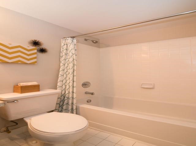a bathroom with a white toilet and a bath tub