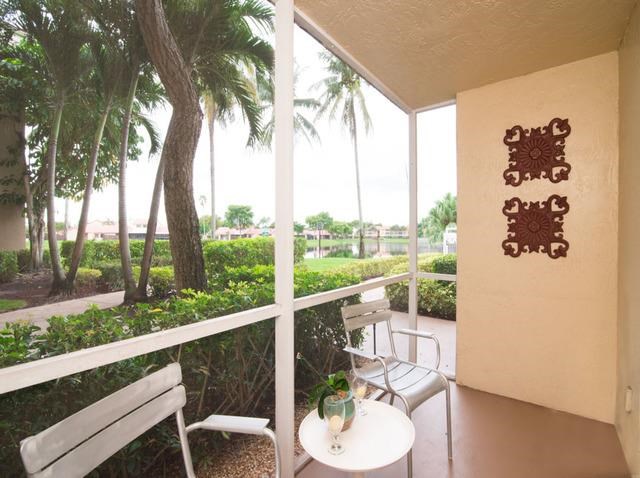 a balcony with two chairs and a table