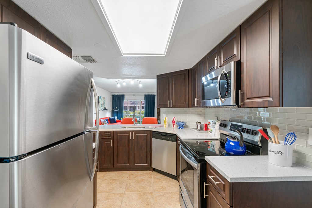 a kitchen with stainless steel appliances and wooden cabinets