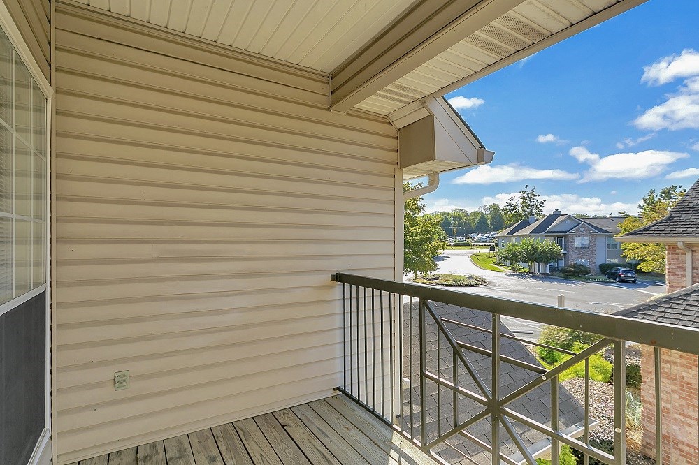 a balcony with a view of a street and houses