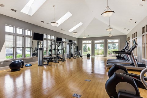 Vernon Hills, IL Luxury Apartments - The Oaks of Vernon Hills - Fitness Center With Elliptical Machines, Treadmills, Free Weights, Weight Training Equipment, and Large Windows.