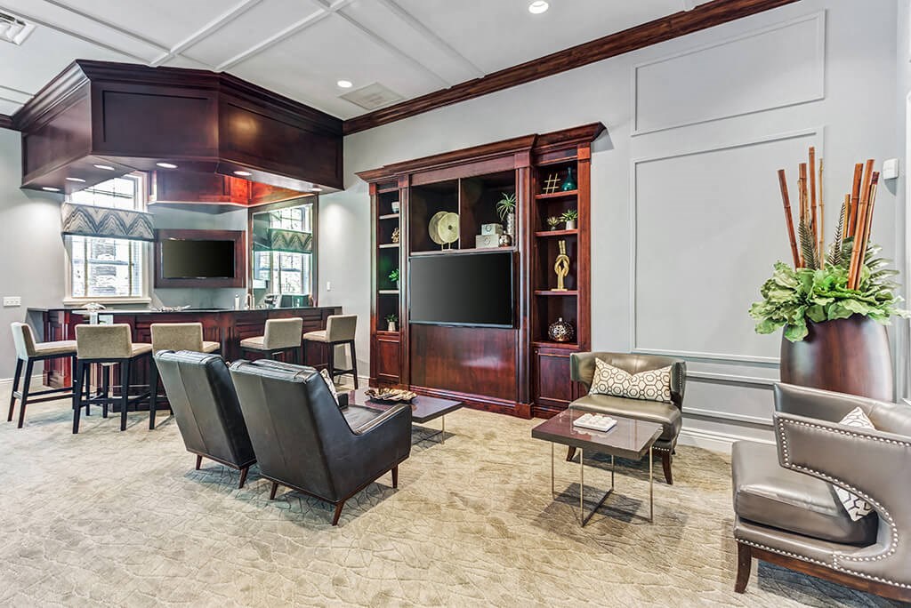 a living room with a table and chairs and a television