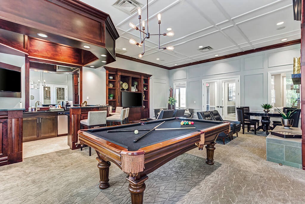 a games room with a pool table and a bar