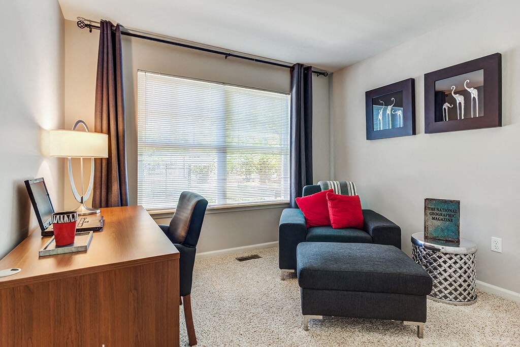 Aurora Apartments - The Apartments at Kirkland Crossing Office With Cozy Carpeting, Large Window, and Modern Decor