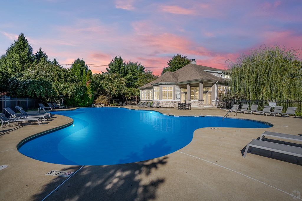 A large swimming pool with a gazebo in the background.