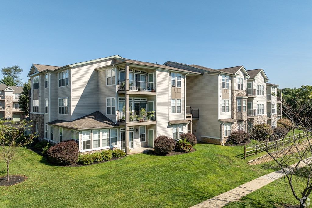 Apartment building with a green lawn in front.