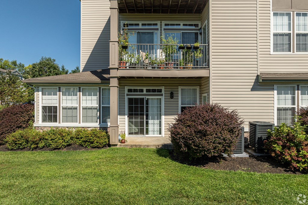 A two-story building with a balcony on the second floor.