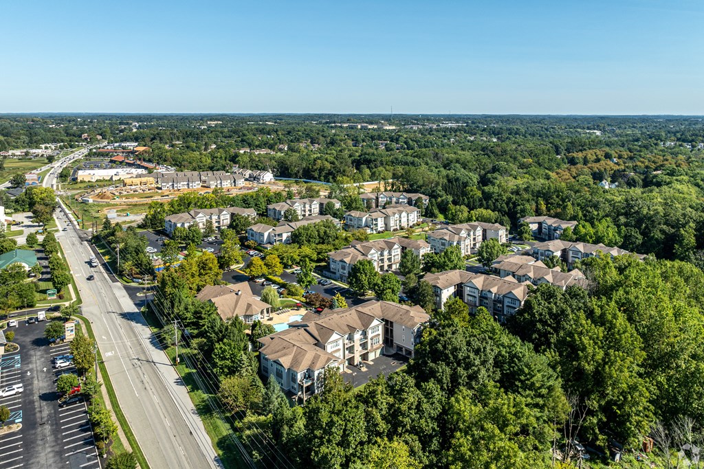 A bird's eye view of a residential area with houses and a road.