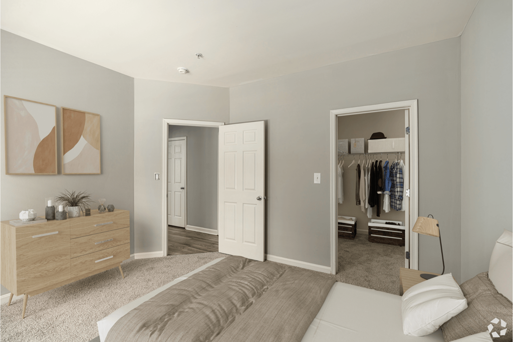 A bedroom with a bed, dresser, and closet.