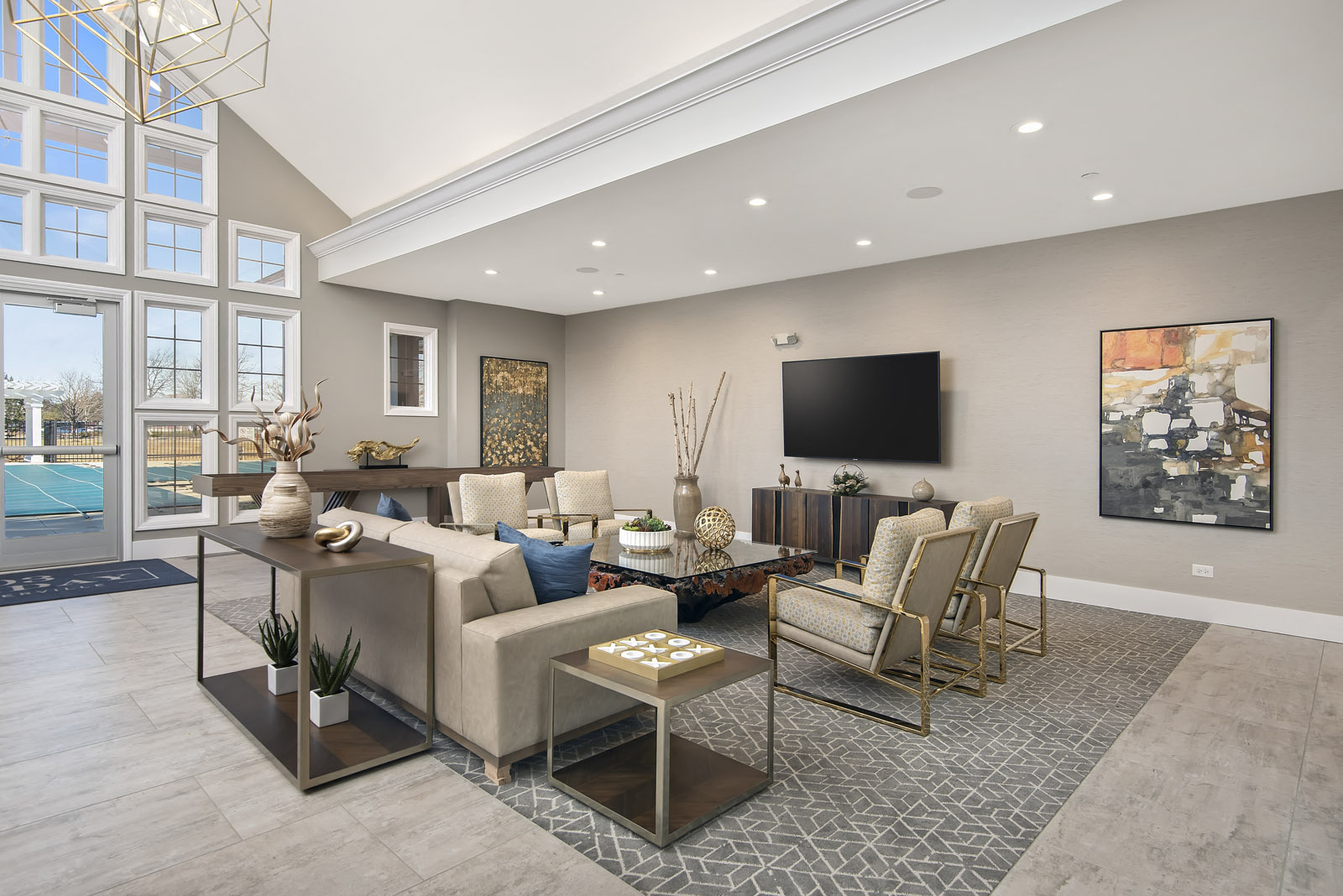 a living room with couches and chairs and a television