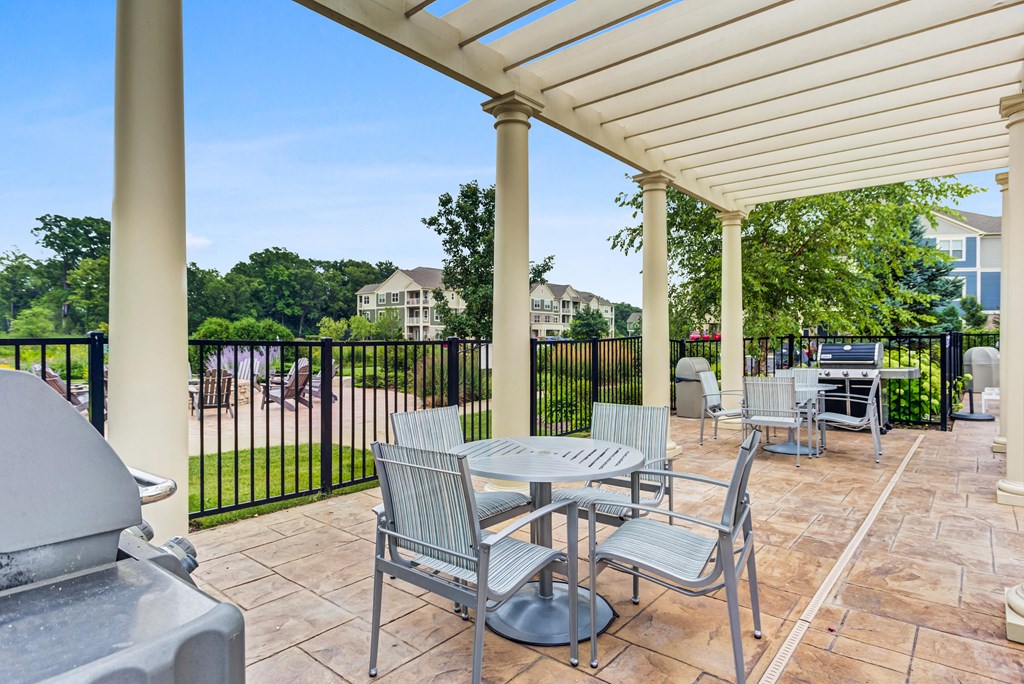 Vernon Hills Luxury Apartments - The Oaks of Vernon Hills - Covered Grill Area with BBQs and Tables with Chairs.