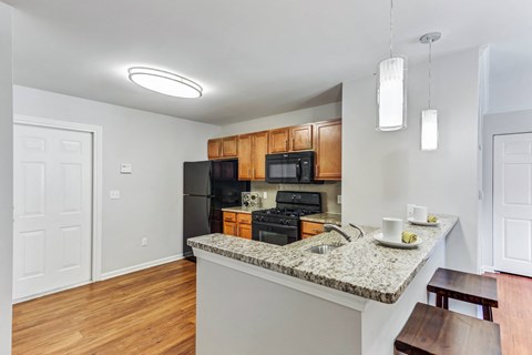 a kitchen with a granite counter top and a black stove