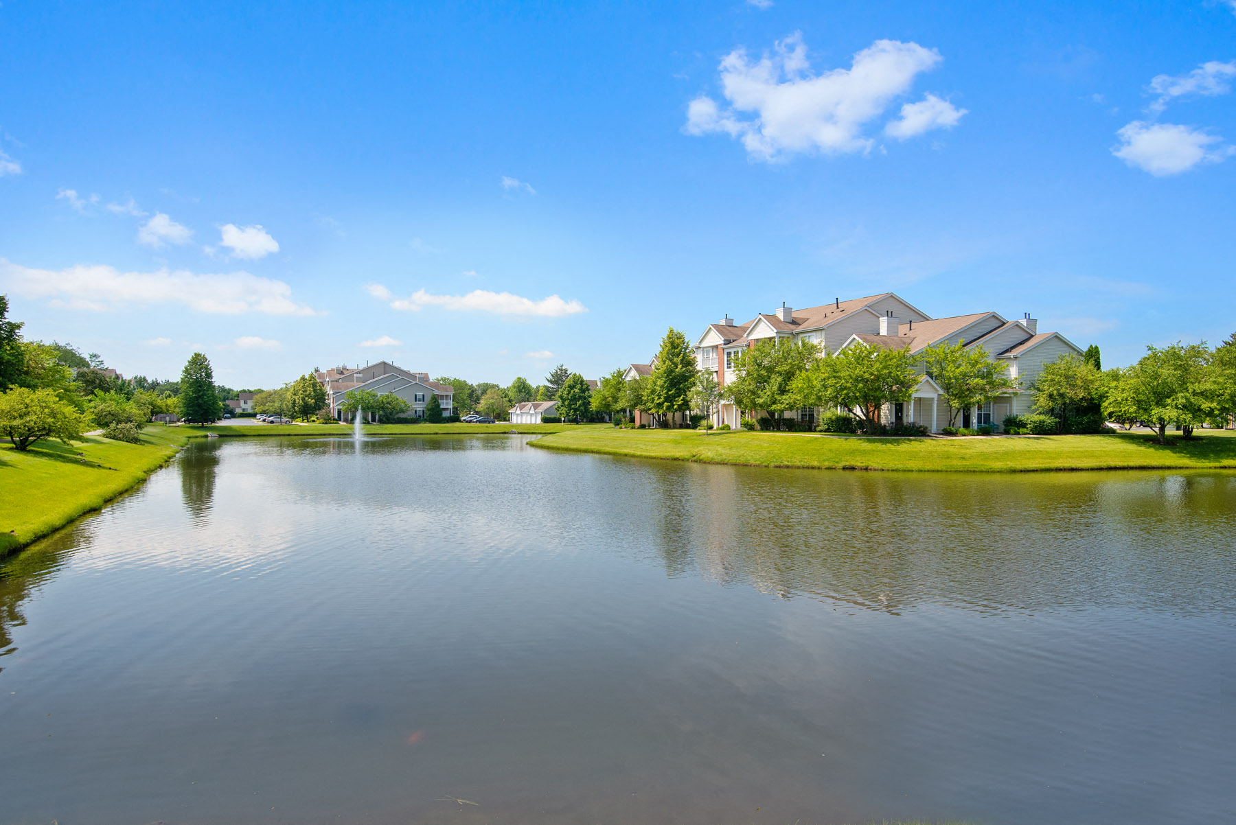 Naperville, IL Apartments - Exterior View of 803 Corday at Naperville Apartments Building Surrounded By Lush Landscaping With Views of Lake