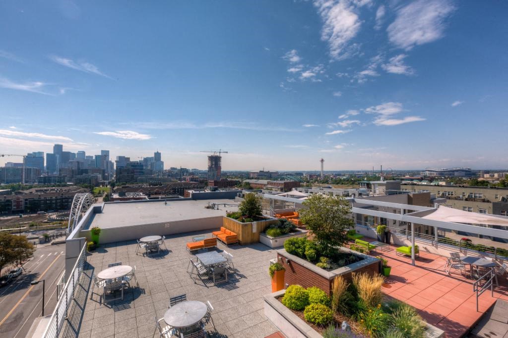 a roof terrace with a view of the city