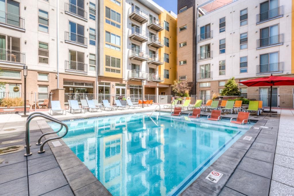 a swimming pool in front of an apartment building