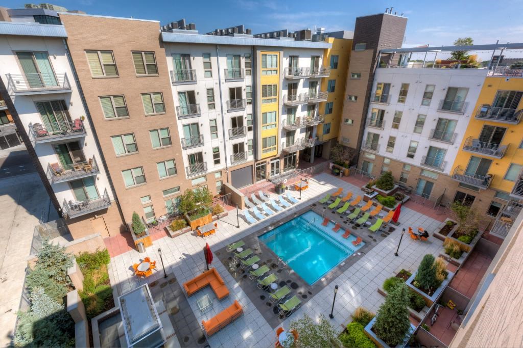 a rendering of an apartment building with a swimming pool