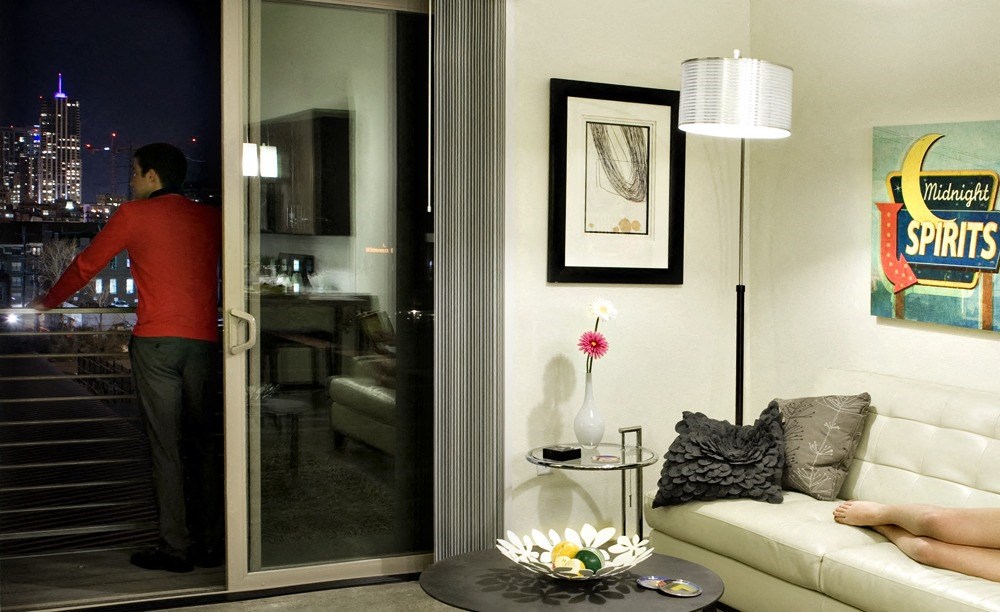 a man standing in a living room next to a glass door