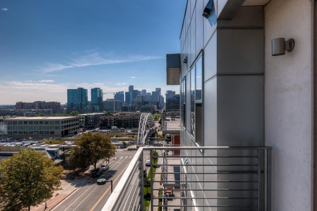 a view of the city from the balcony of a building