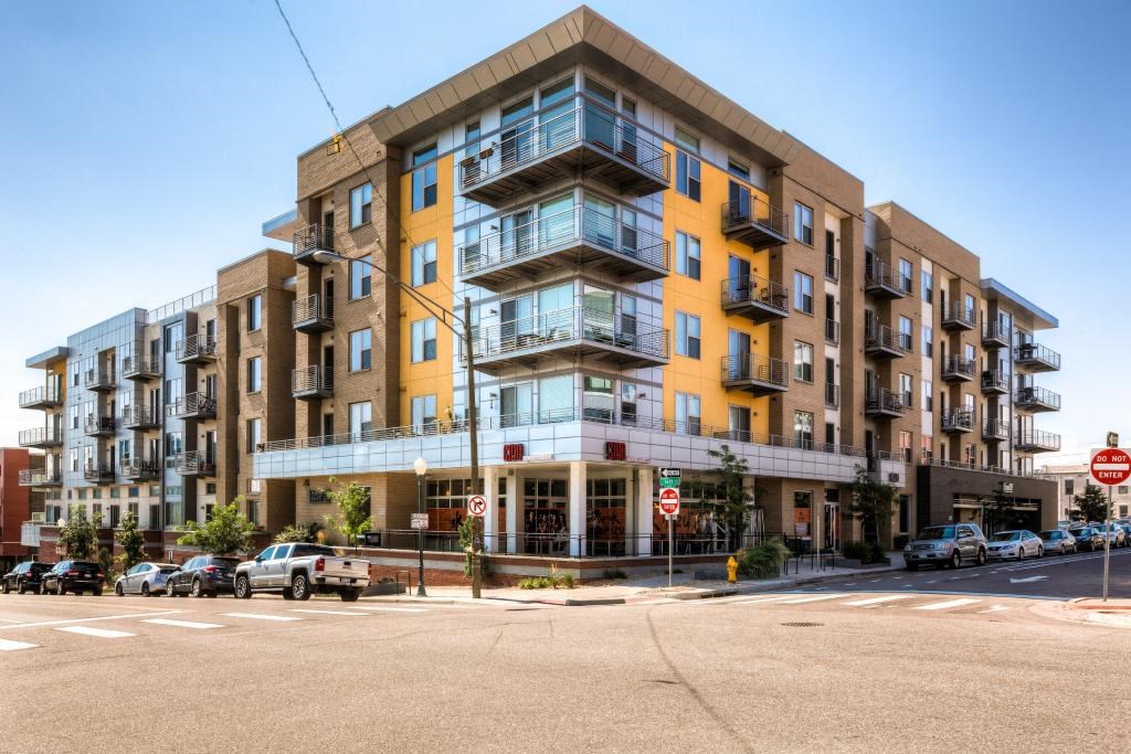 an apartment building on the corner of a street