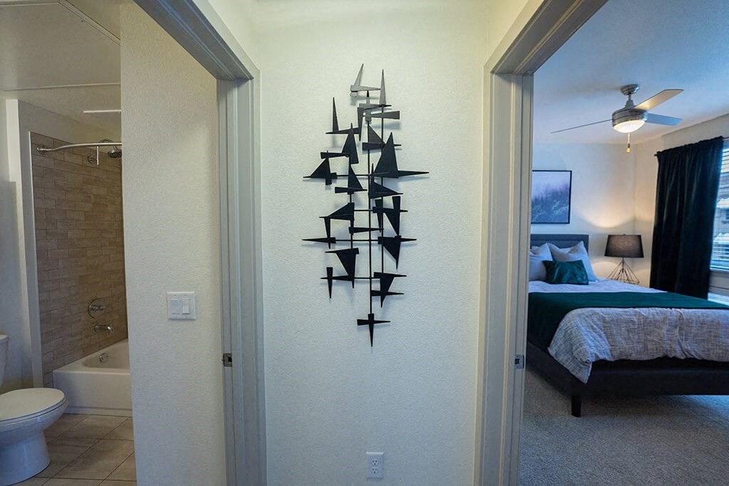 a bedroom with a bed and a bathroom with a