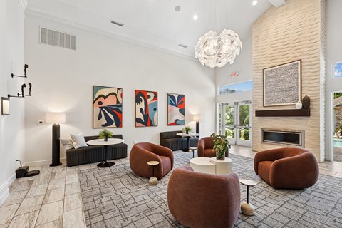 A living room with a fireplace and a painting on the wall.