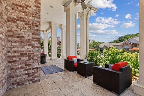 A patio with a brick wall and pillars.