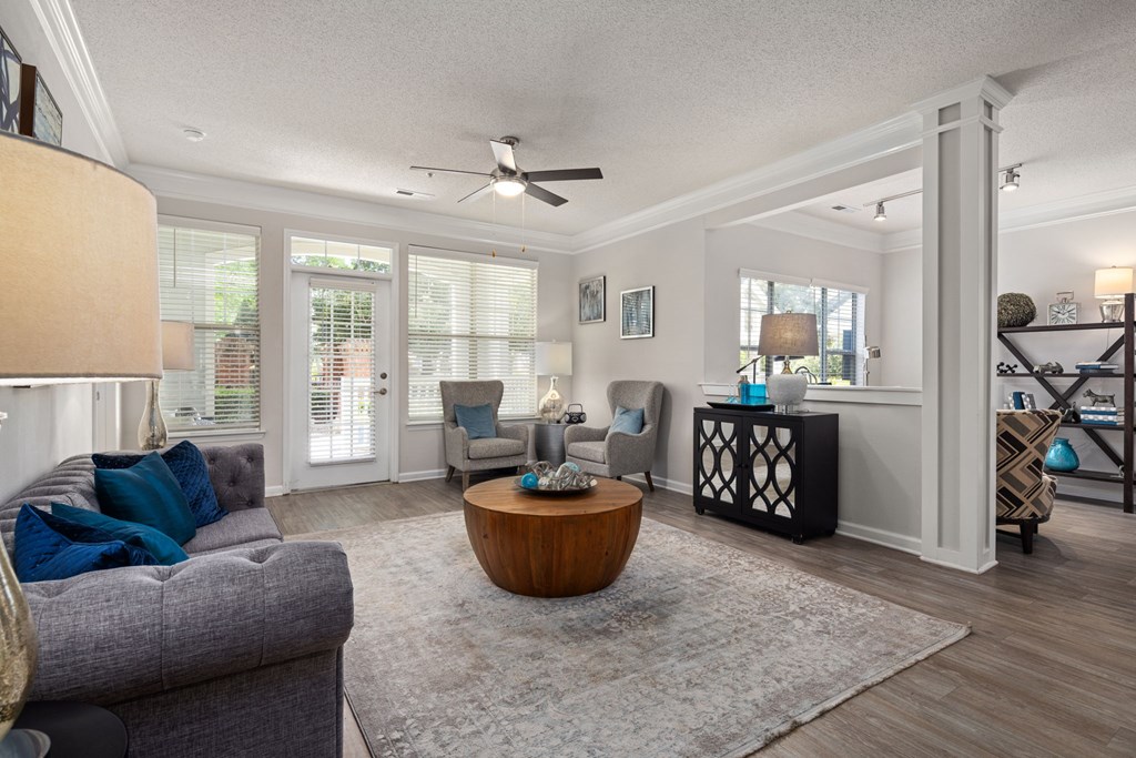 A living room with a grey couch and a wooden coffee table.