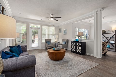 A living room with a grey couch and a wooden coffee table.