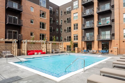 A swimming pool in front of apartment buildings.