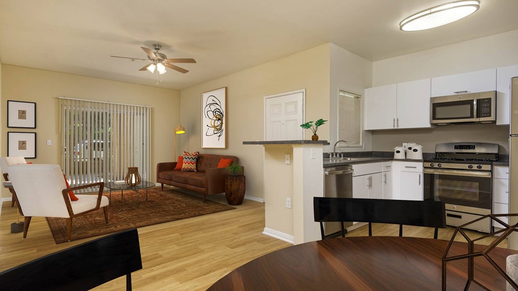 A modern kitchen with a dining area and a living room.
