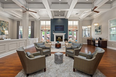 A living room with a fireplace and a large rug.