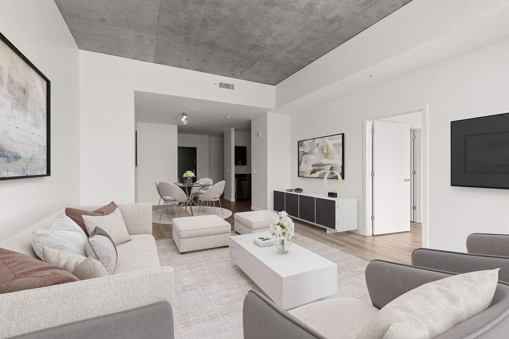 A living room with a grey couch and a coffee table.