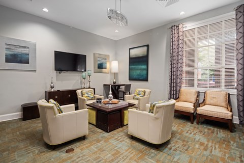 A living room with a sofa, armchair, and coffee table.