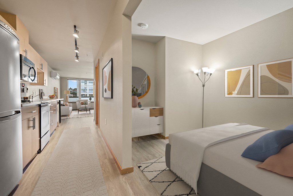 A bedroom with a bed, a couch, and a painting on the wall.