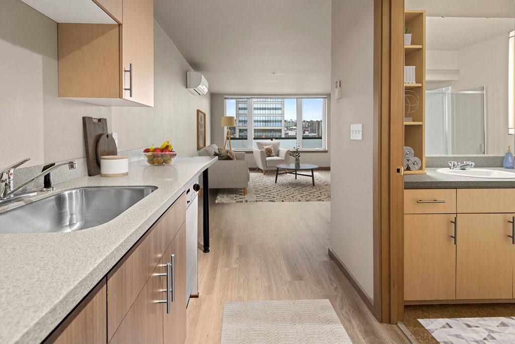 A modern kitchen with a view of the living room.